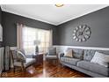 Cozy living room with hardwood floors, stylish furniture, and a window that offers soft natural light at 9955 Woodstock Way, Fishers, IN 46037