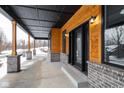 Covered porch with wooden posts and gray brick base, offering views of the backyard at 2101 N Wolf Cv, Martinsville, IN 46151