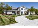 Charming two-story house features an elegant exterior, a spacious lawn, and a winding driveway at 340 Beechwood Farm Ln, Indianapolis, IN 46260
