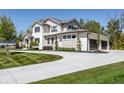 Stunning two-story home showcasing stone and siding, a large driveway, and professional landscaping at 340 Beechwood Farm Ln, Indianapolis, IN 46260