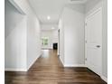 Inviting hallway featuring modern wood floors leading into an open living area with fireplace at 16311 Taconite Dr, Noblesville, IN 46060