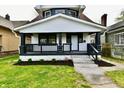Charming two-story home with a welcoming front porch and meticulously maintained landscaping at 3634 N Kenwood Ave, Indianapolis, IN 46208