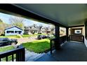 Inviting porch view overlooking a peaceful street with well-maintained homes and lush greenery at 3634 N Kenwood Ave, Indianapolis, IN 46208