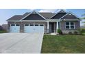 Gray brick house with a 3-car garage at 7834 Fairwood Blvd, Plainfield, IN 46168
