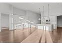 Bright open-concept kitchen featuring white cabinets, island with sink, and stainless steel appliances at 1155 S Rangeline Rd # 506, Carmel, IN 46032