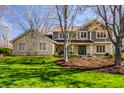 Beautiful two-story home with stone and siding exterior, lush lawn, and inviting curb appeal at 725 Sugarbush Dr, Zionsville, IN 46077