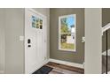 Inviting entryway with a white door, wood floors, and a view of the backyard at 1647 Sheldon St, Indianapolis, IN 46218