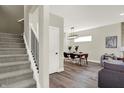 Modern staircase and dining area with wood floors and stylish light fixture at 1647 Sheldon St, Indianapolis, IN 46218