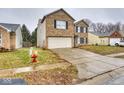 Two-story home with brick and siding, concrete driveway, and well-manicured lawn at 2225 Shadowbrook Dr, Plainfield, IN 46168