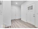 Bright entryway with white walls, wood-look floors, and two entry doors at 5743 Cr W 750 N, McCordsville, IN 46055