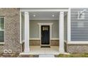 Charming covered porch with white columns and a stylish black front door at 5743 Cr W 750 N, McCordsville, IN 46055