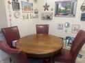 Cozy dining area with a wooden table and red chairs, decorated with charming wall art at 6438 Doris Dr, Indianapolis, IN 46214