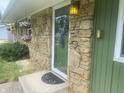 Close-up of the front door showcasing the stone facade and decorative floral arrangements at 6438 Doris Dr, Indianapolis, IN 46214