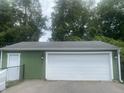 Spacious two-car garage with green siding and white door, offering ample parking at 6438 Doris Dr, Indianapolis, IN 46214