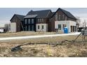 Stunning new construction home featuring a modern design with stone accents and a three-car garage at 9700 Windy Hills Dr, Zionsville, IN 46077