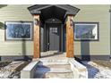 Charming front entrance with wood pillars, a black door, and updated exterior lighting fixtures at 2936 N New Jersey St, Indianapolis, IN 46205