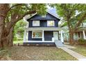 Charming two-story home with inviting front porch and mature trees in a desirable neighborhood at 3031 N New Jersey St, Indianapolis, IN 46205
