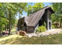 Gray A-frame house with a sloped roof, stone walkway, and lush green lawn at 6420 Oriole Dr, Nineveh, IN 46164