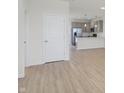 Living room with light hardwood floors and kitchen view at 3885 Wren Dr, Brownsburg, IN 46112