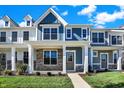 Two-story townhome with gray and blue siding, stone accents, and a front porch at 3893 Wren Dr, Brownsburg, IN 46112