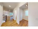 Light and bright hallway with wood floors and access to other rooms at 9870 Bucklebury Ln, Carmel, IN 46280