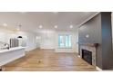 Open living area with fireplace and large windows at 9870 Bucklebury Ln, Carmel, IN 46280