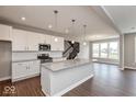 Well-lit kitchen with stainless steel appliances, granite countertops, and seamless open layout at 1099 Gatewick Ct, Greenwood, IN 46143