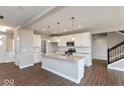 Bright, open kitchen with white cabinets, stainless appliances, and large island at 1099 Gatewick Ct, Greenwood, IN 46143