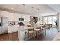 Modern kitchen with island, stainless steel appliances, and white cabinetry at 1099 Gatewick Ct, Greenwood, IN 46143