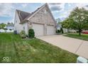 Brick home with attached two-car garage, green lawn and nice landscaping at 7119 Topp Creek Ct, Indianapolis, IN 46214