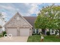 Charming brick home with a manicured lawn, mature tree, and welcoming curb appeal at 7119 Topp Creek Ct, Indianapolis, IN 46214