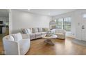 Bright living room featuring a neutral color scheme, hardwood floors, and a large window overlooking the outdoors at 236 Bixler Rd, Indianapolis, IN 46227