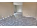 Spacious living room with grey wood-look flooring at 1011 S Elm St, Muncie, IN 47302