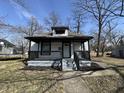 Charming home features a covered front porch with black railings and updated facade at 2869 Stuart St, Indianapolis, IN 46218
