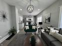 Inviting living room featuring modern decor and ample natural light, transitioning to dining and kitchen at 2869 Stuart St, Indianapolis, IN 46218
