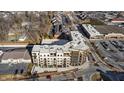 Bird's-eye view of a luxury apartment building, highlighting its location near shops and ample parking at 1155 S Rangeline Rd # 505, Carmel, IN 46032