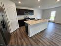Modern kitchen featuring stainless steel appliances, a center island, and dark cabinets at 3202 W Longbranch Dr, Monrovia, IN 46157