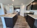 Bright kitchen featuring a large island, modern appliances, and ample counter space at 3202 W Longbranch Dr, Monrovia, IN 46157
