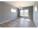 An empty dining room features new flooring, fresh paint, and bright windows at 3725 Maple Ridge Trl, Columbus, IN 47201