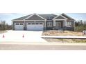 Charming gray home with a two car garage and beautiful stone accents at 3725 Maple Ridge Trl, Columbus, IN 47201