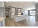 An open-concept kitchen features a large island with seating, and modern appliances at 3725 Maple Ridge Trl, Columbus, IN 47201