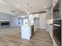 Modern open concept kitchen with an island and gas range flowing into the living room at 3725 Maple Ridge Trl, Columbus, IN 47201