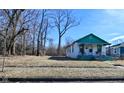 Quaint one-story home with green trim, a covered porch, and a modest front lawn at 3111 Station St, Indianapolis, IN 46218