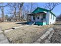 Exterior view of a compact, one-story home with an inviting porch and a tidy front yard at 3111 Station St, Indianapolis, IN 46218