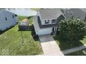 Well-maintained home featuring a two-car garage, spacious driveway, and lush green lawn at 3335 Hurst St, Whiteland, IN 46184
