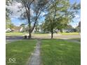 Picturesque street view showcasing a well-manicured lawn and a welcoming neighborhood setting at 712 Lonsvale Dr, Anderson, IN 46013