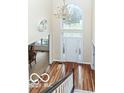 Grand foyer with hardwood floors, chandelier, and arched window providing natural light at 14626 Warner Trl, Westfield, IN 46074