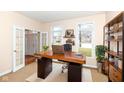 Bright home office featuring wood desk, shelving, and french doors to living area at 14626 Warner Trl, Westfield, IN 46074