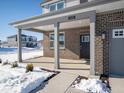 Covered front porch with brick columns and a dark-colored door at 1420 Chime Ln, Greenwood, IN 46143