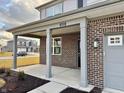 Covered front porch with brick columns and walkway at 1420 Chime Ln, Greenwood, IN 46143